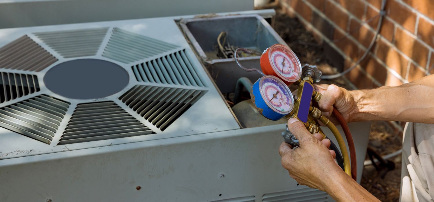 An HVAC technician checks refrigerant pressure on an outdoor air conditioning unit during a service call in Tucson, AZ.